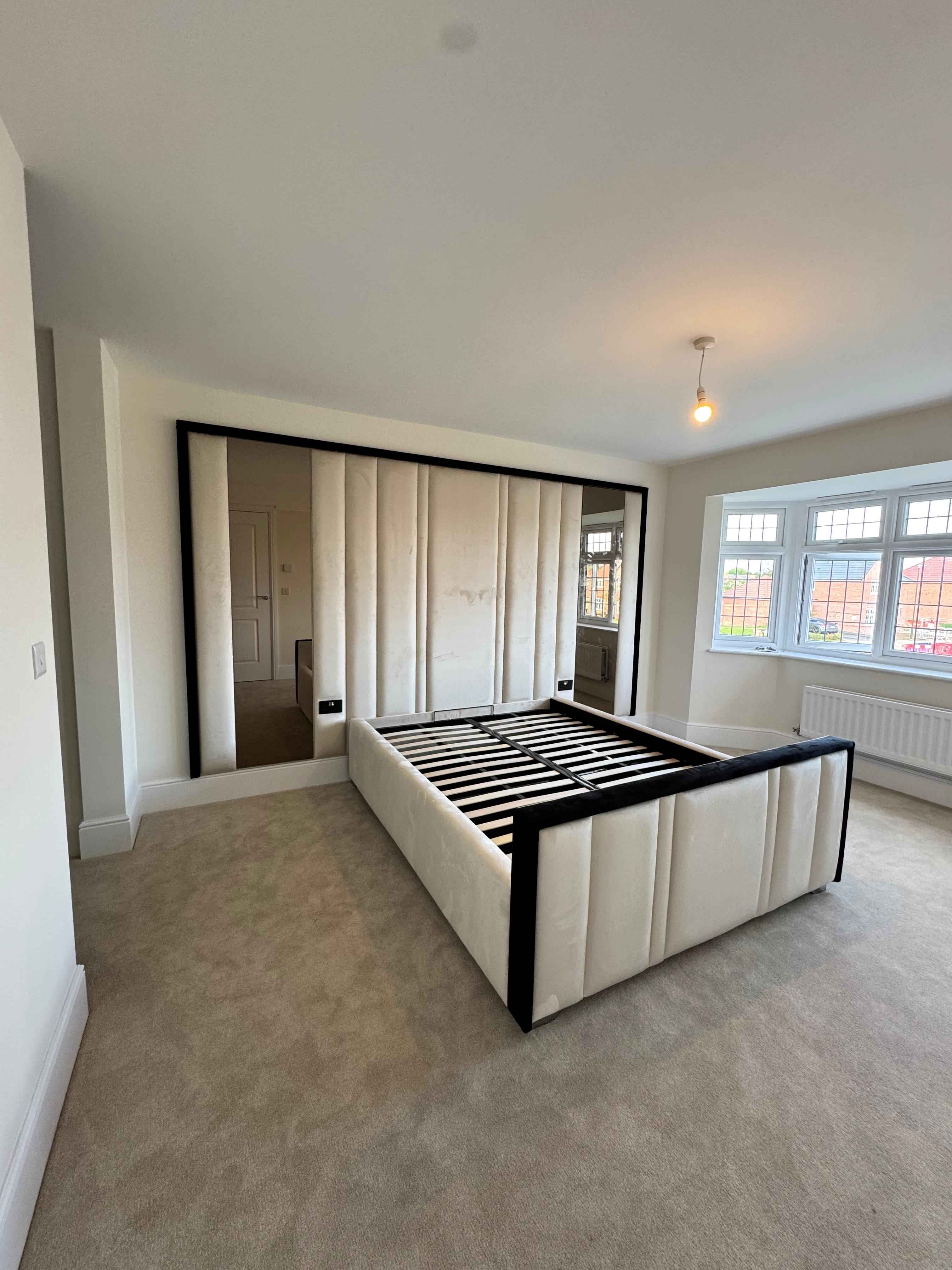 Upholstered wall panelling behind bed – contemporary wall panel headboard design