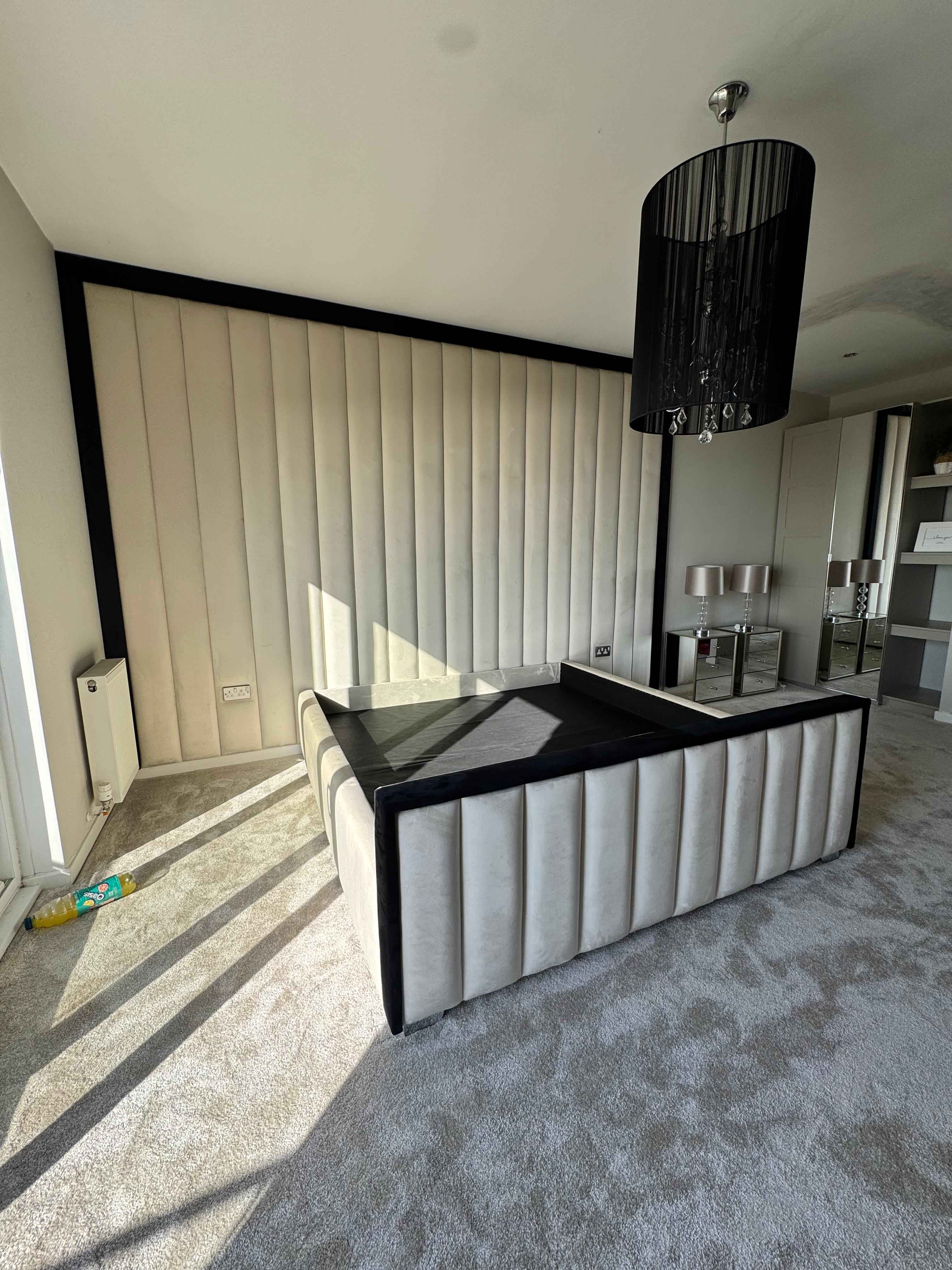 Bed with upholstered wall panels – modern feature wall panelling for bedrooms UK